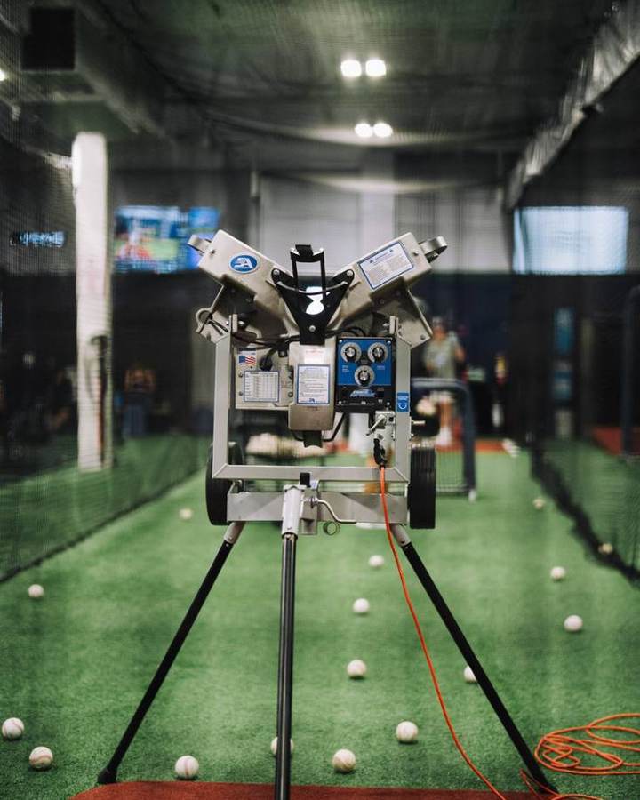 Pitching machine set up in a cage